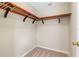 Empty walk-in closet offering ample storage with custom wood shelving and carpeted flooring at 3346 Pegaso Ave, New Smyrna Beach, FL 32168
