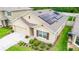 Aerial view of a charming single-Gathering home featuring solar panels, a manicured lawn, and a two-car garage at 339 Spruce Pine Dr, Debary, FL 32713
