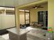 Cozy screened-in back patio with a ceiling fan, chairs, and a table, perfect for outdoor relaxation at 339 Spruce Pine Dr, Debary, FL 32713
