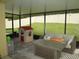 Inviting screened-in patio with sofa and playhouse offering a relaxed outdoor living space at 339 Spruce Pine Dr, Debary, FL 32713