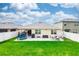 Expansive backyard with lush lawn, trampoline, and outdoor seating perfect for entertaining at 339 Spruce Pine Dr, Debary, FL 32713