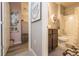 Hallway bathroom with vanity, shower-tub combo, and gray flooring and wall decor at 339 Spruce Pine Dr, Debary, FL 32713