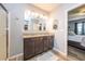 Bathroom with granite vanity top and dual sinks across from primary bedroom at 339 Spruce Pine Dr, Debary, FL 32713