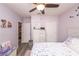 Bright bedroom featuring floral bedding, modern decor, and wood-look floors at 339 Spruce Pine Dr, Debary, FL 32713