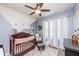 Comfortable Bedroom features a cozy rocking chair, crib, and natural light at 339 Spruce Pine Dr, Debary, FL 32713