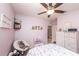 Charming bedroom with a ceiling fan, plush chair, and pastel decor at 339 Spruce Pine Dr, Debary, FL 32713