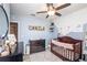 Bright Bedroom with stylish decor featuring pastel walls, crib, and changing table at 339 Spruce Pine Dr, Debary, FL 32713