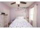 Cozy bedroom featuring floral bedding, a decorative tree mural, and neutral-toned dresser at 339 Spruce Pine Dr, Debary, FL 32713