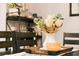 Staged dining room table centerpiece with flowers, candle, and decorative tray at 339 Spruce Pine Dr, Debary, FL 32713