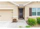 Close up of a cozy front porch with a dark wooden door and seasonal decorations at 339 Spruce Pine Dr, Debary, FL 32713