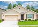 Inviting single-story home with a well-manicured lawn, charming exterior, and a two-car garage at 339 Spruce Pine Dr, Debary, FL 32713