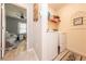 Hallway view leading to a bright living space with a laundry area at 339 Spruce Pine Dr, Debary, FL 32713