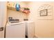 Well-equipped laundry room featuring modern appliances and storage shelves at 339 Spruce Pine Dr, Debary, FL 32713