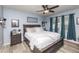 Bedroom featuring a large bed, two nightstands, decorative wall art, and neutral decor at 339 Spruce Pine Dr, Debary, FL 32713