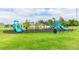 A community playground with slides, swings, and benches on a well-maintained green lawn at 339 Spruce Pine Dr, Debary, FL 32713