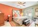 Cozy bedroom with colorful accent wall, decorative headboard, ceiling fan, and bright natural light at 347 Admiralty Ct, Edgewater, FL 32141