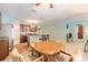 Open dining area featuring a wood table, four chairs, and carpet flooring at 347 Admiralty Ct, Edgewater, FL 32141