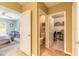 Hallway leading to a bedroom, water closet, and office space with carpet and tile flooring at 347 Admiralty Ct, Edgewater, FL 32141