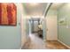 Bright hallway leads to the front door, accented by decorative lamps and neutral wall colors at 347 Admiralty Ct, Edgewater, FL 32141