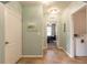 Neutral hallway leading to a bedroom and laundry area, blending practicality and aesthetics at 347 Admiralty Ct, Edgewater, FL 32141