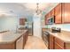 Well-lit kitchen with stainless steel appliances, ample counter space, and wood cabinets at 347 Admiralty Ct, Edgewater, FL 32141