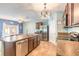 Spacious kitchen featuring stainless steel appliances, central island, and views to dining area at 347 Admiralty Ct, Edgewater, FL 32141