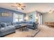 Spacious living room featuring a sectional sofa, ceiling fan, and lots of natural light at 347 Admiralty Ct, Edgewater, FL 32141