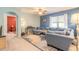 Open-concept living room with blue walls, carpet, and ample natural light at 347 Admiralty Ct, Edgewater, FL 32141