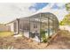 A screened-in pool and patio area boasts a small garden and privacy from the yard at 347 Admiralty Ct, Edgewater, FL 32141