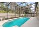 The screened-in pool offers an ideal space for relaxation with a serene, private setting at 347 Admiralty Ct, Edgewater, FL 32141