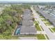 An aerial view of a street in the community with tree lined street and sidewalks on either side at 347 Admiralty Ct, Edgewater, FL 32141