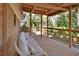 Relaxing back porch featuring a wooden deck, a pergola, and a wicker sofa with plush pillows at 351 W Holly Dr, Orange City, FL 32763