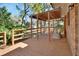 Inviting back porch with a wooden deck, a pergola, and comfortable wicker furniture, perfect for relaxing at 351 W Holly Dr, Orange City, FL 32763