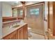 Bathroom with a large glass shower and vanity with golden hardware at 351 W Holly Dr, Orange City, FL 32763