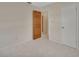 Clean, simple bedroom has a wooden door, tile flooring and a closet for ample storage at 351 W Holly Dr, Orange City, FL 32763