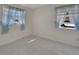 This bedroom features two large windows, tile flooring, and is awaiting decor at 351 W Holly Dr, Orange City, FL 32763