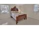 Classic-style bedroom features a decorative wood frame bed and large, bright windows at 351 W Holly Dr, Orange City, FL 32763