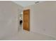 Neutral toned bedroom features tile floors, a light colored wall, and a wood door to another room at 351 W Holly Dr, Orange City, FL 32763