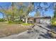 Beautiful single-story home with a long driveway and a well-manicured front yard at 351 W Holly Dr, Orange City, FL 32763