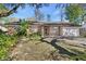 Charming brick home with a well-maintained lawn and mature landscaping at 351 W Holly Dr, Orange City, FL 32763