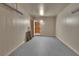 Spacious garage with a clean gray floor and access to the home's interior through a wood door at 351 W Holly Dr, Orange City, FL 32763