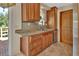 Bright kitchen with stainless steel appliances and wooden cabinets by the sink at 351 W Holly Dr, Orange City, FL 32763