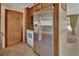 Kitchen with stainless steel refrigerator, and white oven, adjacent to the living space at 351 W Holly Dr, Orange City, FL 32763