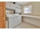 Functional laundry room with ample cabinetry, a large countertop, and modern washing machines at 351 W Holly Dr, Orange City, FL 32763