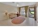 Cozy living room featuring neutral walls, tile floors, and natural light at 351 W Holly Dr, Orange City, FL 32763