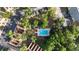 Aerial view of community pool surrounded by lush greenery and residential buildings at 3960 Willow Trail Run # 45, Port Orange, FL 32127