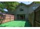 Private backyard with low maintenance turf, enclosed by a wooden fence, and accessible through sliding glass doors at 3960 Willow Trail Run # 45, Port Orange, FL 32127