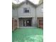 Backyard with artificial turf, privacy fence, and sliding glass doors to the living area at 3960 Willow Trail Run # 45, Port Orange, FL 32127