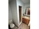 Bathroom vanity with wooden cabinets and a tiled shower stall at 3960 Willow Trail Run # 45, Port Orange, FL 32127