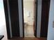 A bathroom with a tiled shower, a sink, a toilet and wood-stained doors at 3960 Willow Trail Run # 45, Port Orange, FL 32127